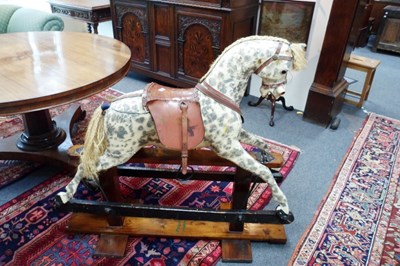 Lot 590 - A dapple grey rocking horse on American...