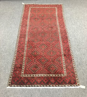 Lot 692 - A Baluchi rug, the red ground with all over...