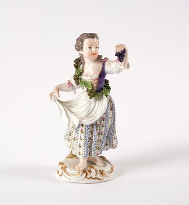 Lot 909 - A Meissen figure of a girl with grapes, 14cm high