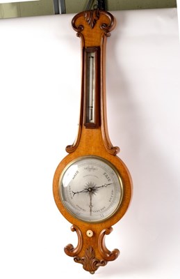 Lot 1011 - A Regency oak wheel barometer with thermometer...