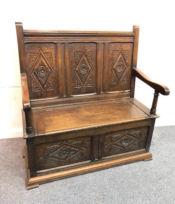 Lot 1052 - A 17th Century style oak settle with carved...