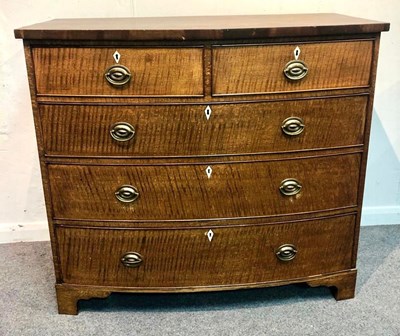 Lot 1063 - An oak bowfront chest of two short over three...