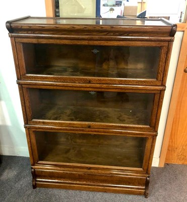 Lot 1064 - A Globe Wernicke oak bookcase with three glass...