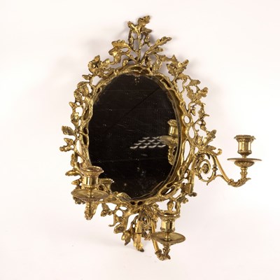 Lot 1074 - An oval wall mirror, the gilt brass frame with...