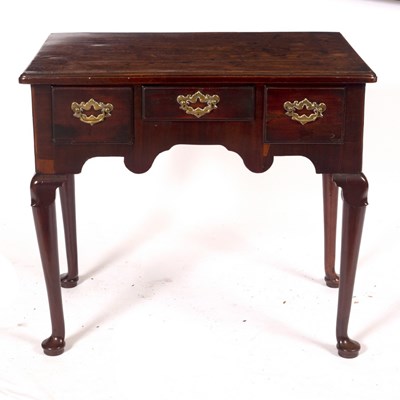 Lot 1077 - A George II mahogany three-drawer side table,...