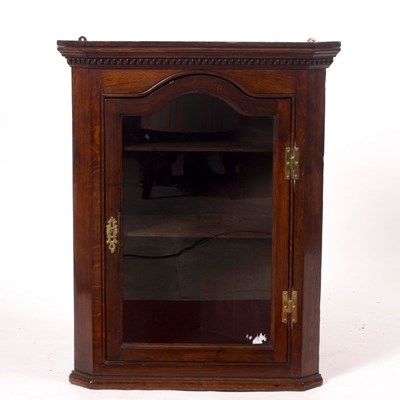 Lot 1124 - An early 19th Century oak corner cupboard...