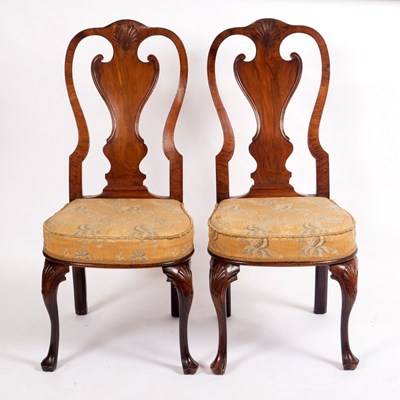 Lot 1136 - A pair of walnut single chairs with carved...