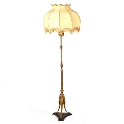 Lot 1154 - A brass standard lamp of reeded and twisted...