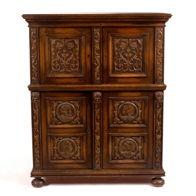 Lot 1169 - An oak cupboard enclosed by a pair of scroll...