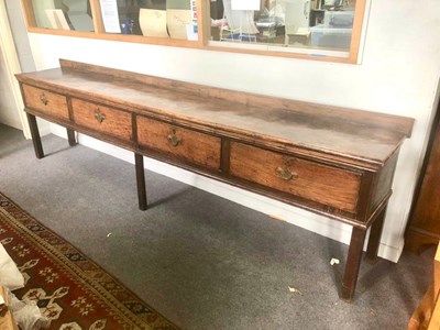 Lot 1201 - An early 19th Century oak and elm dresser, the...