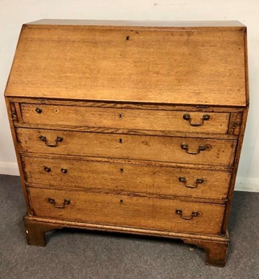 Lot 1203 - An oak bureau, the fall front with fitted...