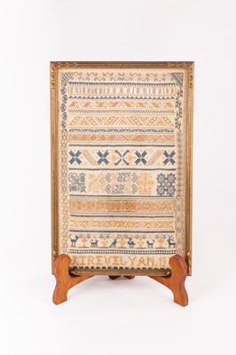 Lot 30 - A needlework sampler with text and alphabet...