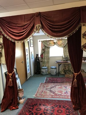 Lot 91 - A pair of red velvet swagged curtains with tie...