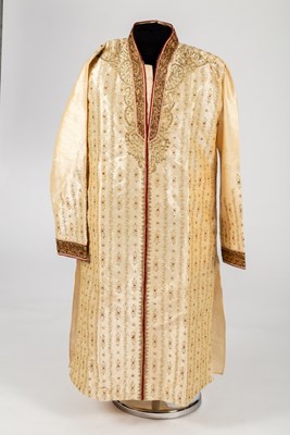 Lot 329 - An Indian cream silk coat with gold and claret...