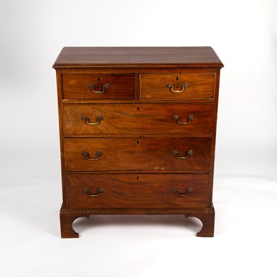 Lot 393 - A Georgian mahogany chest of three long and...