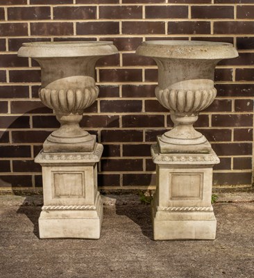 Lot 503 - A pair of reconstituted stone garden vases on...