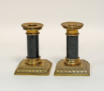 Lot 554 - A pair of brass candlesticks with serpentine...