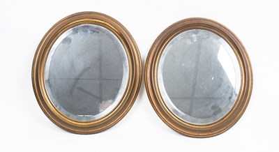 Lot 562 - Two small brass oval mirrors with bevelled...