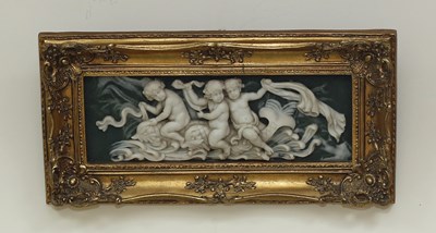 Lot 563 - A resin plaque depicting putti riding dolphins,...