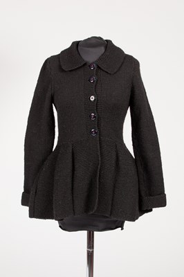 Lot 682 - Redheart, England, a black knitted wool peplum...