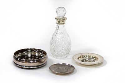 Lot 19 - A small silver mounted decanter, a silver wine...