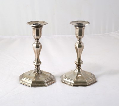 Lot 101 - A pair of Edwardian silver candlesticks,...