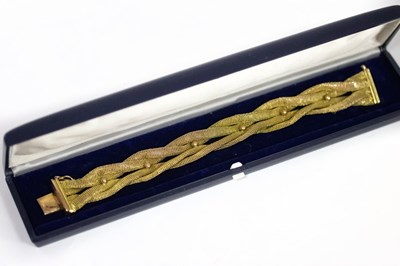 Lot 163 - A 14ct yellow gold bracelet of four interlaced...