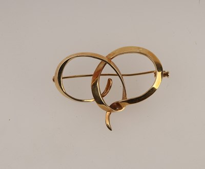 Lot 177 - An 18ct gold brooch, London 2000, of entwined...