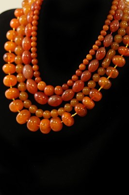 Lot 188 - Three amber bead necklaces and an agate bead...