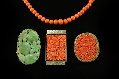 Lot 189 - A carved jade brooch modelled as pumpkins, in...