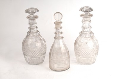 Lot 243 - A pair of cut glass triple-ring neck decanters...