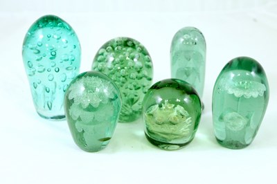 Lot 251 - Six green glass dumps, the largest 14.5cm high