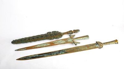 Lot 415 - Three Chinese bronze swords and one scabbard