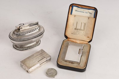 Lot 437 - A Dunhill Elite cigarette lighter in an engine...