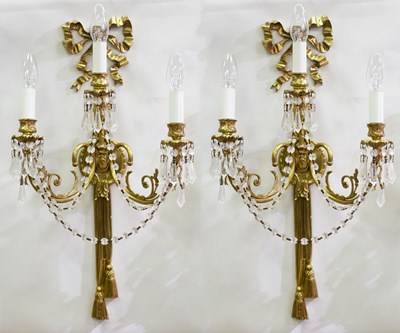 Lot 457 - A pair of gilt metal three-branch wall sconces,...