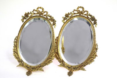 Lot 461 - A pair of gilt metal framed oval mirrors, with...