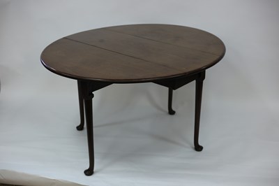 Lot 527 - A George III mahogany oval two-flap table on...