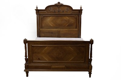 Lot 538 - An early 20th Century walnut bed, the head and...