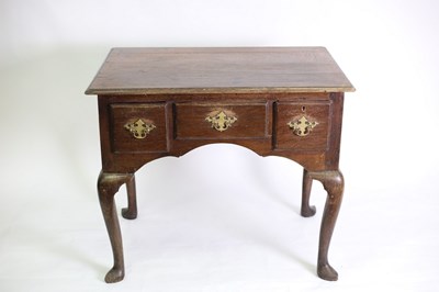 Lot 542 - An oak lowboy table fitted a surround of three...