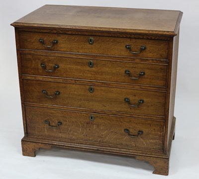 Lot 583 - A George III oak chest of four long graduated...