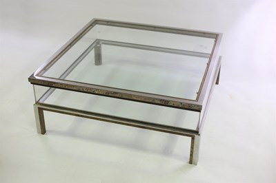 Lot 585 - A chrome and glass coffee table in the manner...