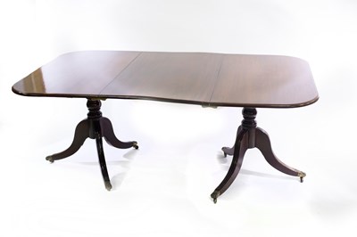 Lot 590 - A Regency style mahogany dining table, of twin...