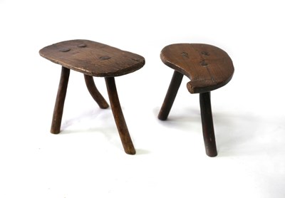 Lot 662 - A small three-legged elm stool, the oval top...