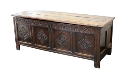 Lot 711 - An 18th Century oak chest, the hinged cover...