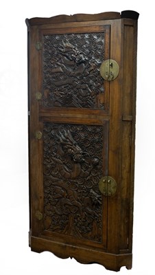 Lot 735 - A Chinese corner cupboard enclosed by dragon...