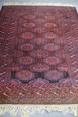 Lot 760 - A Bokarah style rug of crimson ground, the...