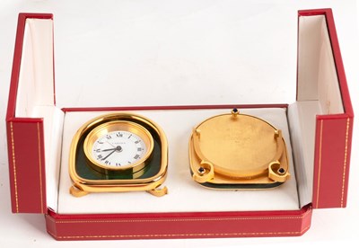 Lot 784 - A Cartier alarm clock, 8cm high and a picture...