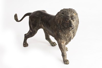 Lot 810 - A bronze figure of a standing lion, 45cm long