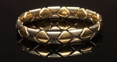 Lot 21 - An 18ct bi-colour gold bracelet, of...