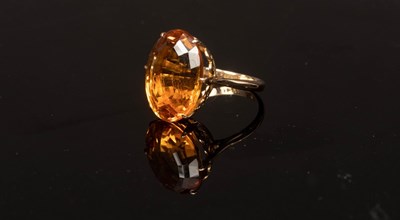 Lot 26 - A citrine cocktail ring, the oval stone in an...